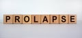 Concept word `prolapse` on wooden cubes on a beautiful white background. Medical concept, copy space