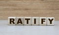 Concept of the word RATIFY on cubes on a wooden background Royalty Free Stock Photo