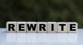 The concept of the word REWRITE on cubes on a beautiful green background Royalty Free Stock Photo