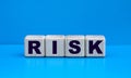 concept word RISK on cubes on a blue background Royalty Free Stock Photo