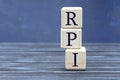 Concept word RPI on cubes on a beautiful gray blue background