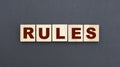 Concept word RULES on wooden cubes on a gray background