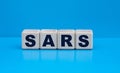 concept word SARS on cubes on a blue background Royalty Free Stock Photo