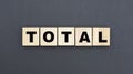 Concept word TOTAL on wooden cubes on a gray background