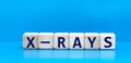 concept word X-RAYS on cubes on a blue background Royalty Free Stock Photo