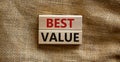 Concept words `best value` on wooden blocks on a beautiful canvas background. Business concept