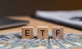 Concept words ETF on wooden blocks, acronym ETF which refers to Exchange Traded Fund inscribed on wooden cubes United States