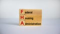Concept words `FHA, federal housing administration` on cubes and blocks on a beautiful white background. Business concept. Copy