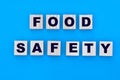 Concept words food safety on cubes on a blue background