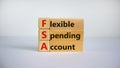 Concept words `FSA, flexible spending account` on cubes and blocks on a beautiful white background. Copy space Royalty Free Stock Photo