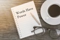 Concept Words Have Power message on notebook with glasses, pencil and coffee cup on wooden table.