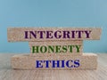 Concept words Integrity honesty ethics on brick blocks. Beautiful blue background. Wooden table Royalty Free Stock Photo