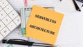 Concept words SERVERLESS ARCHITECTURE it is written on a sticker on the background of an open notebook Royalty Free Stock Photo