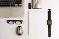 Office desk or executive desk with laptop, white sheet book, glasses, external hard drive, computer mouse and memory USB, digita Royalty Free Stock Photo