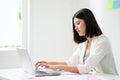 Young asian business woman working on computer laptop in office room with paperwork document Royalty Free Stock Photo