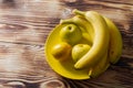 The concept of yellow on yellow. Yellow whole lemon, apples and bananas on a plate