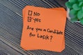 Concept of Are you a Candidate for Lasik? Yes write on sticky notes isolated on Wooden Table