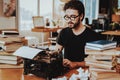 Concept of Young Guy Working on Typewriter Royalty Free Stock Photo