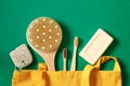 Textile eco friendly bags, soap, bamboo toothbrush, soap accessories on a green background. Top view or flat lay. Concept of zero Royalty Free Stock Photo