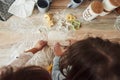 Conception of cooking. Top view of kids learning to prepare food from the flour with special formed instruments