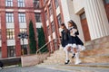 Conception of education. Two schoolgirls is outside together near school building Royalty Free Stock Photo