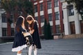 Conception of friendship. Two schoolgirls is outside together near school building Royalty Free Stock Photo