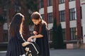 Conception of friendship. Two schoolgirls is outside together near school building Royalty Free Stock Photo