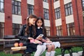 Conception of friendship. Two schoolgirls is outside together near school building Royalty Free Stock Photo