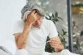 Conception of illness and virus. Senior stylish modern man with grey hair and beard indoors Royalty Free Stock Photo