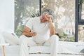 Conception of illness and virus. Senior stylish modern man with grey hair and beard indoors Royalty Free Stock Photo