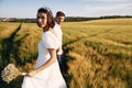 Conception of love. Couple just married. Together on the majestic agricultural field at sunny day Royalty Free Stock Photo