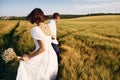 Conception of love. Couple just married. Together on the majestic agricultural field at sunny day Royalty Free Stock Photo