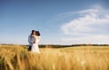 Conception of love. Couple just married. Together on the majestic agricultural field at sunny day Royalty Free Stock Photo