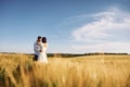 Conception of love. Couple just married. Together on the majestic agricultural field at sunny day Royalty Free Stock Photo