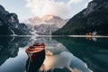 Conception of traveling. Wooden boat on the crystal lake with majestic mountain behind. Reflection in the water. Chapel Royalty Free Stock Photo