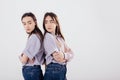 Conception of two offended family members. Two sisters twins standing and posing in the studio with white background Royalty Free Stock Photo