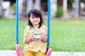 Concepts of children saving and planning for the future. Child girl smiled sweetly while holding a large coin jar of money. A Royalty Free Stock Photo