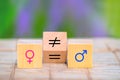 Concepts of gender equality. Wooden cube with symbol unequal change to equal sign