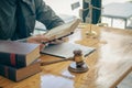 Concepts of justice and lawyers discuss contract paperwork with brass scales on a table with a judge`s hammer placed in front of l Royalty Free Stock Photo