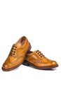 Closeup of A Pair of Full Broggued Tan Leather Oxfords Shoes.