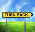 Conceptual arrow sign against beautiful landscape with text - TURN BACK