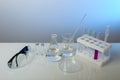 Conceptual background with chemical flasks. blue backdrop with lab glassware with copy space. Royalty Free Stock Photo