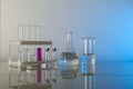 Conceptual background with chemical flasks. blue backdrop with lab glassware with copy space. Royalty Free Stock Photo