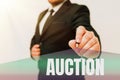 Conceptual caption Auction. Business overview Public sale Goods or Property sold to highest bidder Purchase Presenting