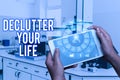 Conceptual caption Declutter Your Life. Word for To eliminate extraneous things or information in life Hands Holding A Royalty Free Stock Photo