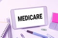 Conceptual caption Medicare. Business approach the federal government plan in US for paying certain hospital Smartphone