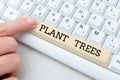 Text caption presenting Plant Trees. Word for process of planting a tree for land cultivation and forestry Editing