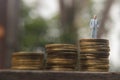 Conceptual Close Up Photo, Standing Man at Rupiah Golden Coin, ilustration for successful or wealth