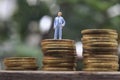 Conceptual Close Up Photo, Standing Man at Rupiah Golden Coin, ilustration for successful or wealth