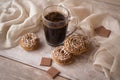 Conceptual coffee morning image, cup of black coffee with beige cookies and chocolate. Symbolic image. Wooden shabby background